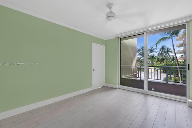 empty room with floor to ceiling windows and crown molding