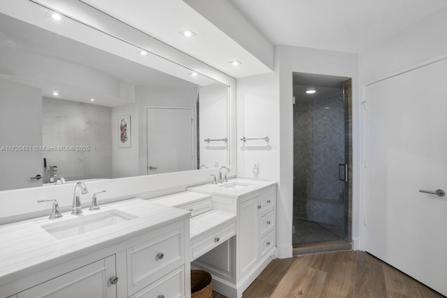 bathroom featuring an enclosed shower, vanity, and hardwood / wood-style flooring