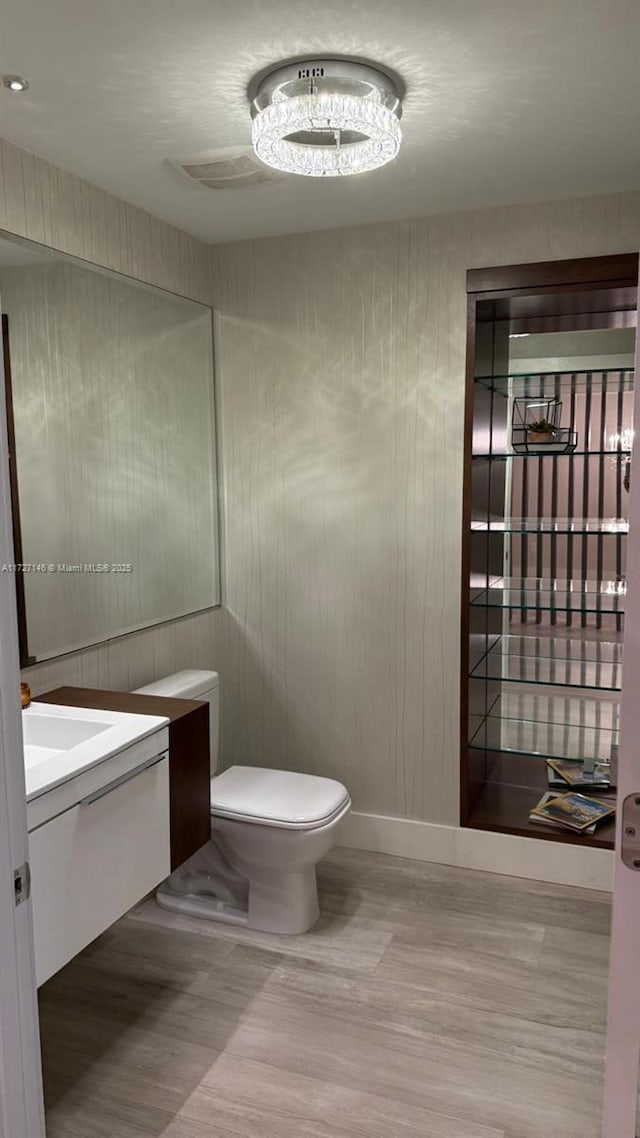 bathroom featuring toilet and vanity