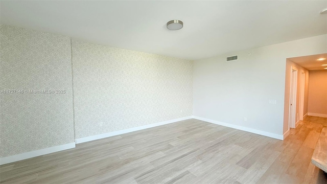 spare room with light wood-type flooring