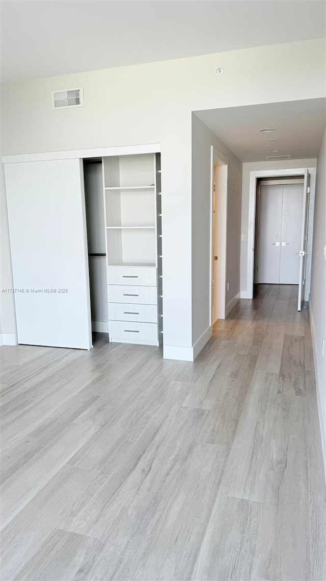 unfurnished bedroom featuring light wood-type flooring