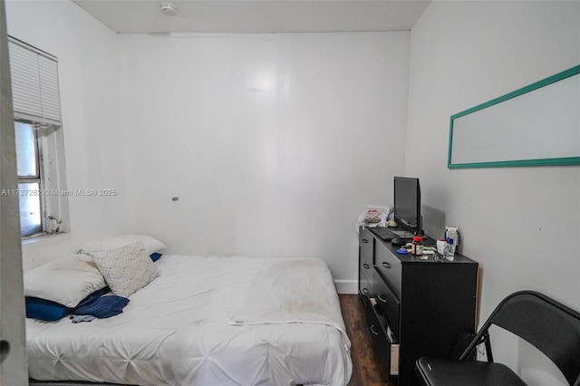 bedroom with dark hardwood / wood-style floors