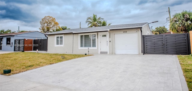 ranch-style home with a front lawn and a garage