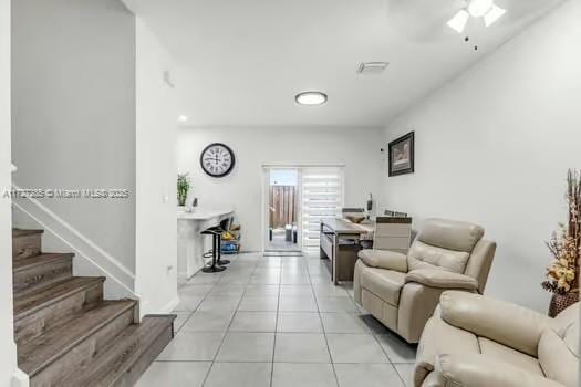 living room featuring ceiling fan and light tile patterned floors