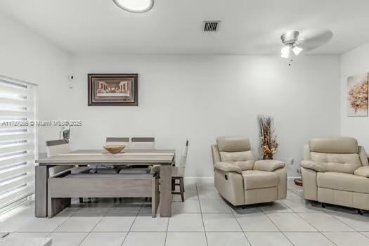 dining space featuring ceiling fan and light tile patterned flooring