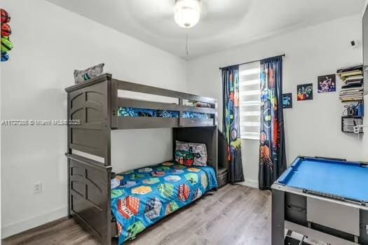 bedroom with ceiling fan and wood-type flooring