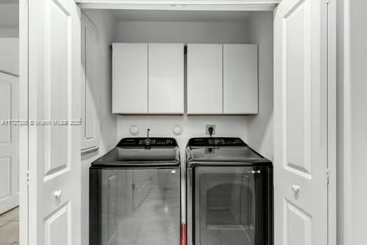 laundry area featuring cabinets and separate washer and dryer