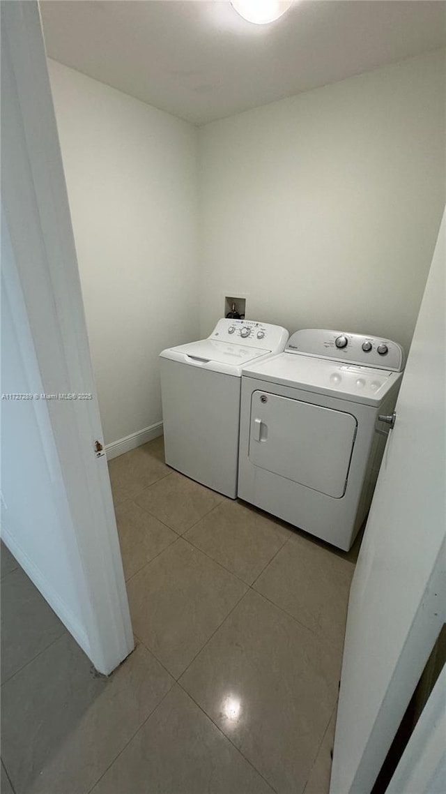 washroom featuring light tile patterned floors and separate washer and dryer