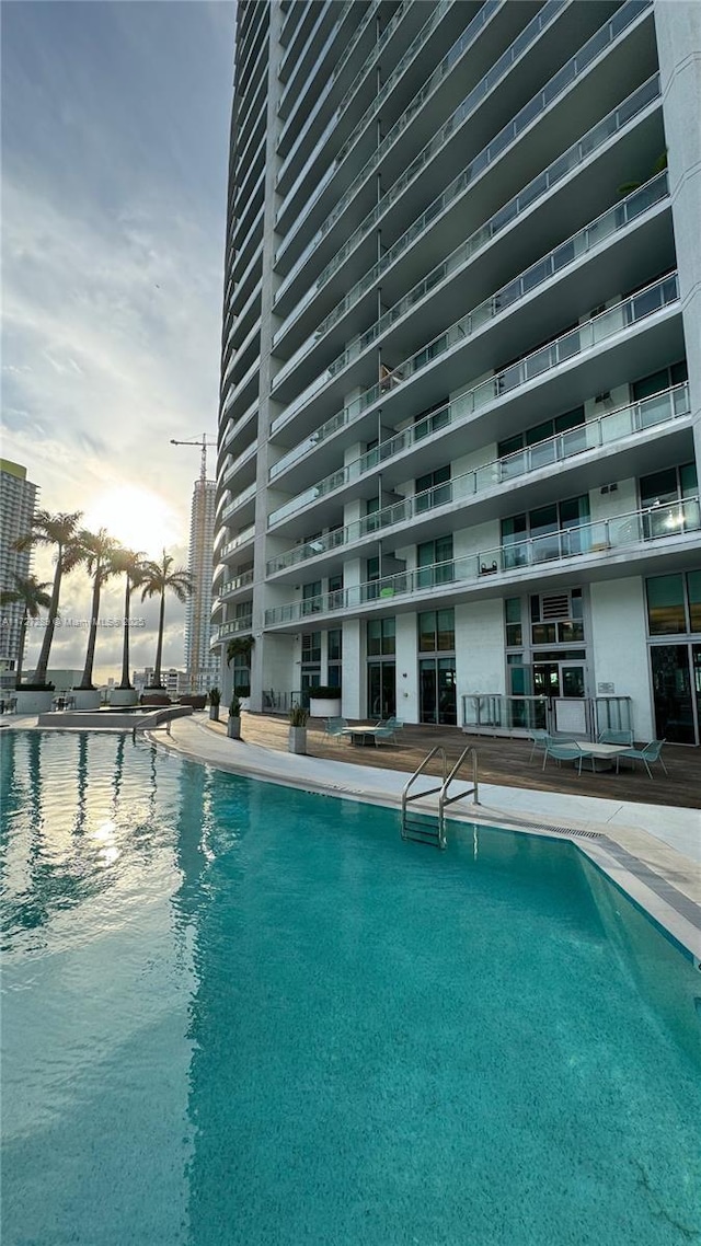 view of pool at dusk