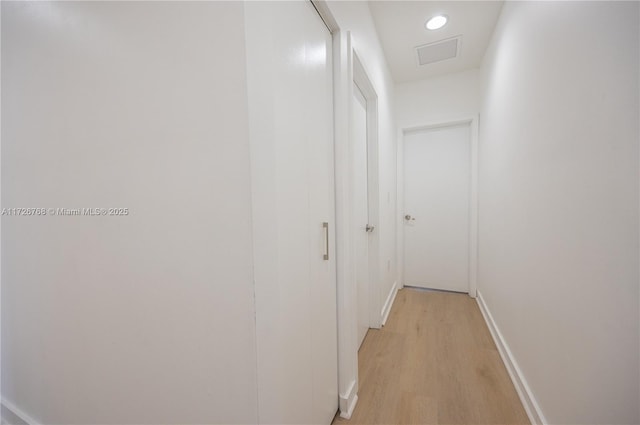 corridor with light hardwood / wood-style flooring