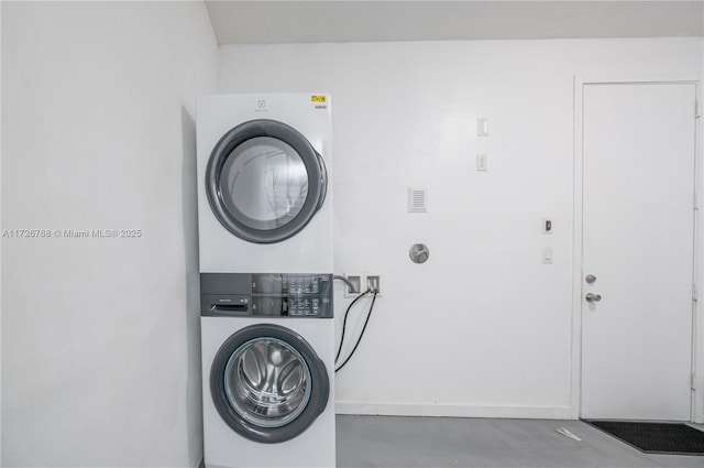 laundry area featuring stacked washer / dryer