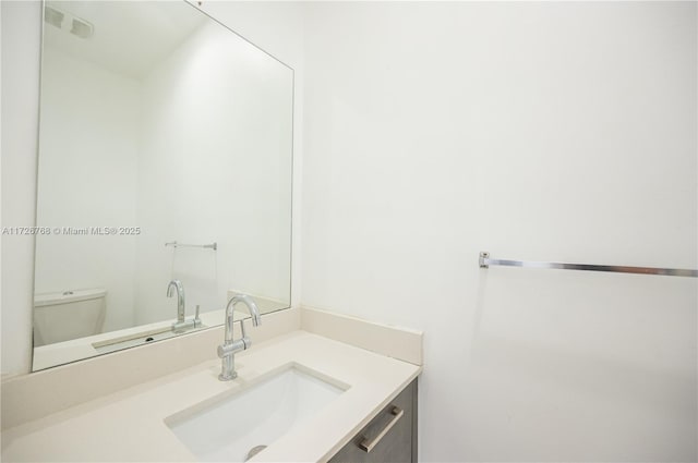 bathroom with toilet and vanity