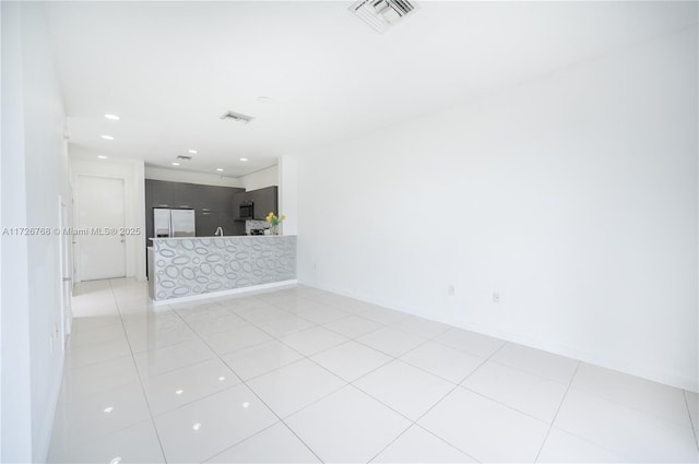 spare room with light tile patterned floors