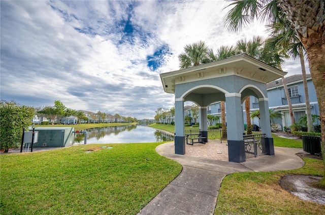 view of property's community featuring a water view, a gazebo, and a lawn