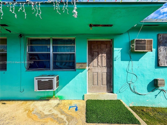 entrance to property featuring a wall mounted air conditioner