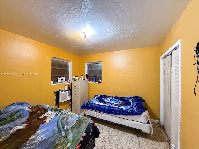 bedroom with a closet and a textured ceiling