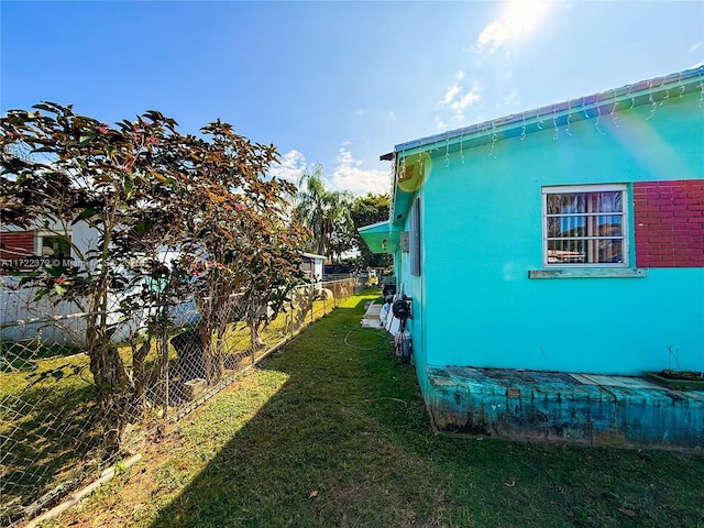 view of home's exterior with a yard