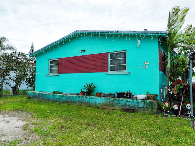 view of side of home featuring a yard