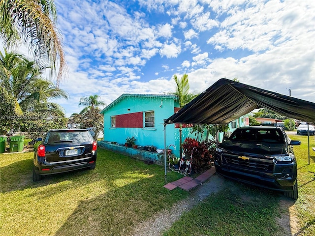 view of parking / parking lot with a lawn and a carport