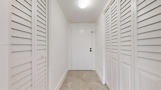 corridor featuring light tile patterned floors