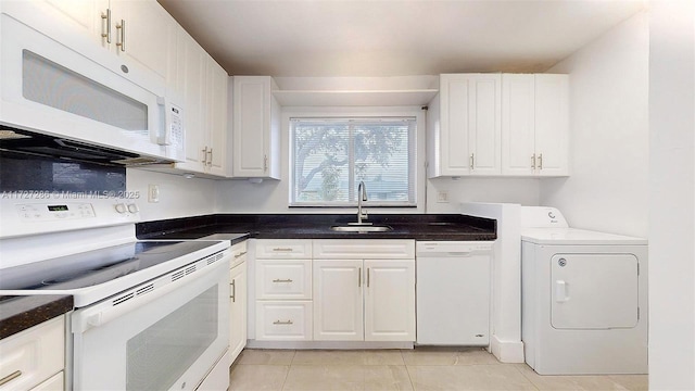 kitchen with washer / dryer, white appliances, light tile patterned flooring, white cabinets, and sink