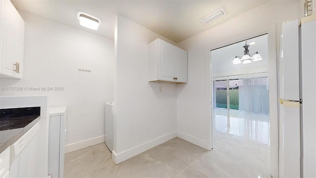 bathroom featuring tile patterned floors and a notable chandelier