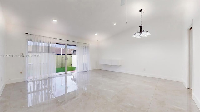 spare room featuring a high ceiling and an inviting chandelier