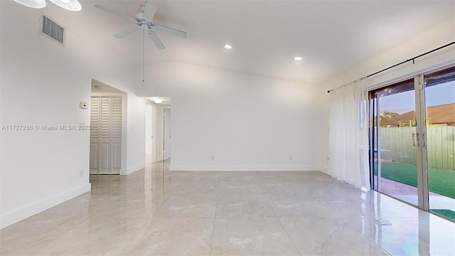 unfurnished room with ceiling fan and a high ceiling