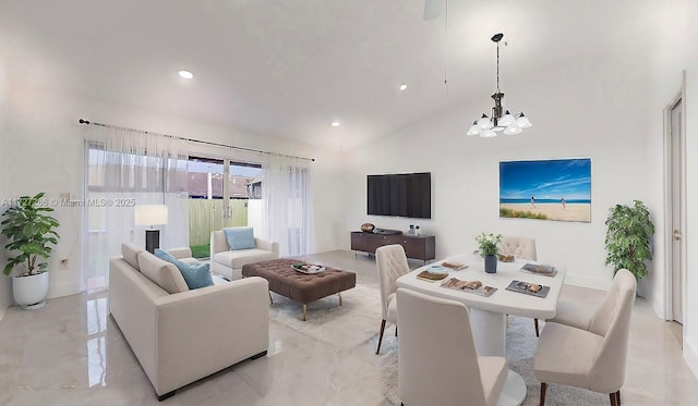 living room with an inviting chandelier and high vaulted ceiling