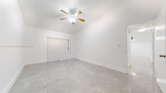 unfurnished room with ceiling fan and vaulted ceiling