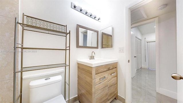 bathroom featuring toilet and vanity