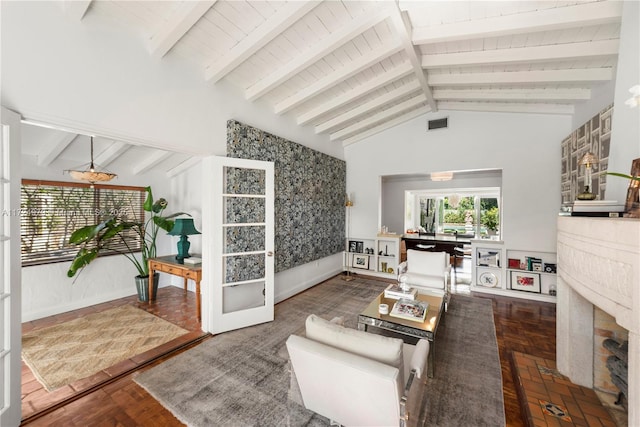 living room with lofted ceiling with beams and dark parquet flooring