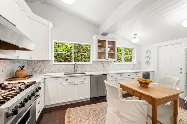 kitchen featuring light stone counters, sink, stainless steel appliances, and vaulted ceiling with beams