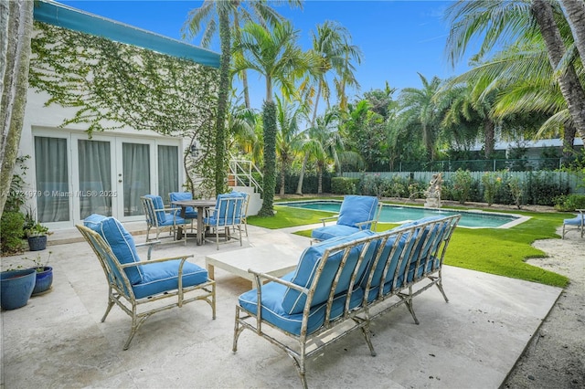 view of patio featuring an outdoor hangout area, french doors, and a fenced in pool