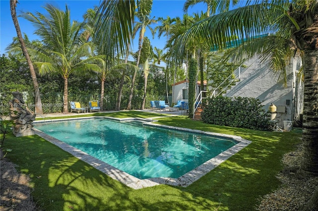 view of pool featuring a patio area and a yard