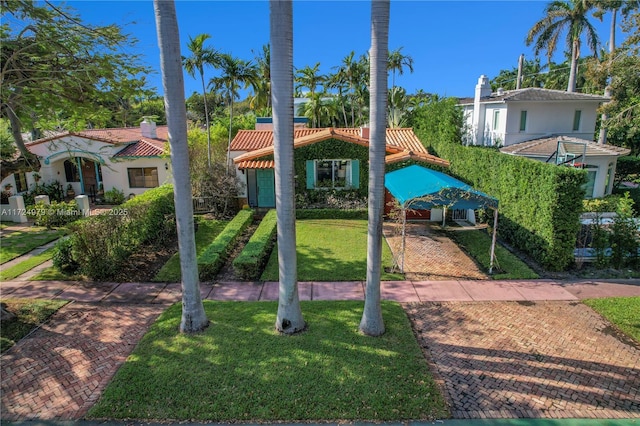 mediterranean / spanish house featuring a front yard