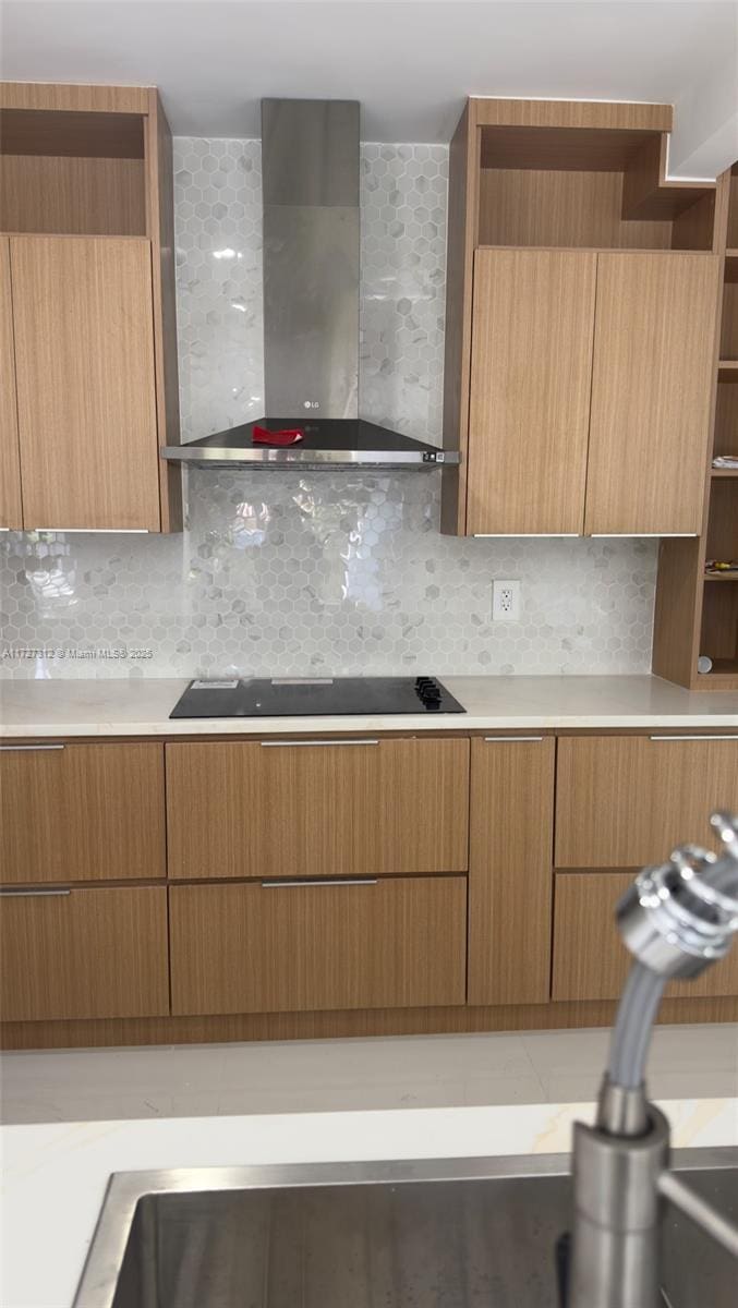 kitchen featuring light countertops, wall chimney exhaust hood, black electric stovetop, and open shelves