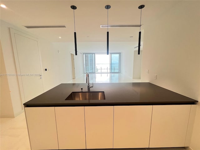 kitchen with decorative light fixtures and sink