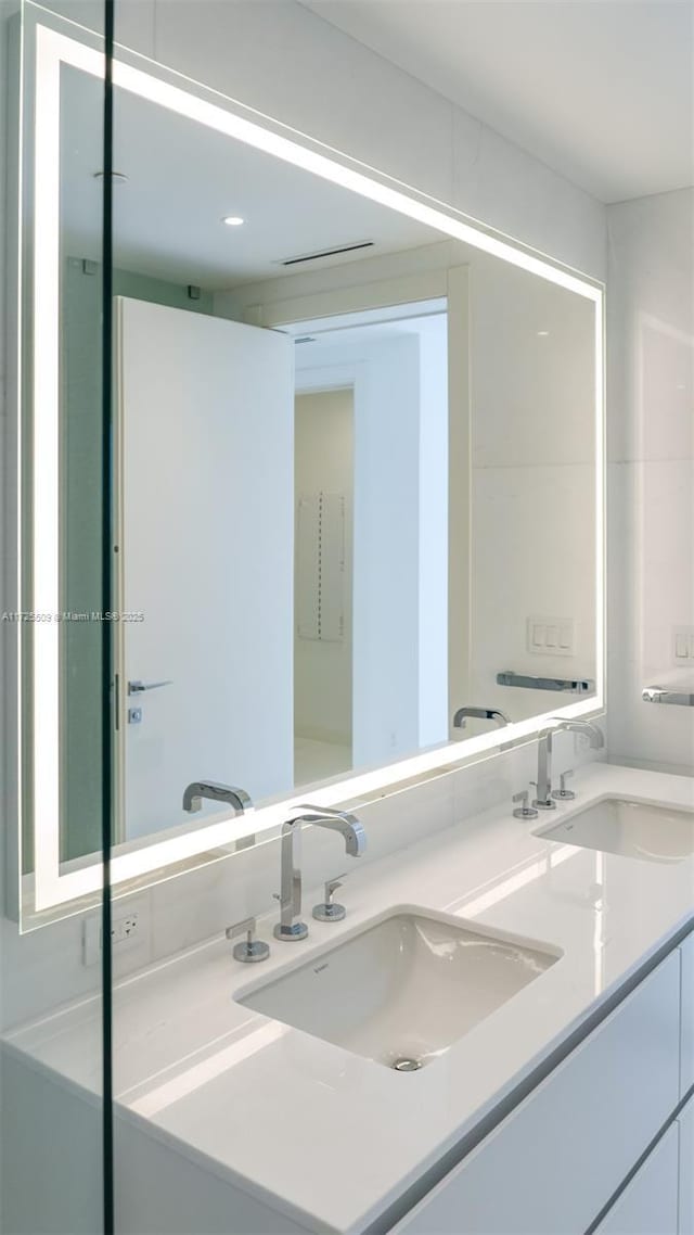 bathroom with a sink and double vanity