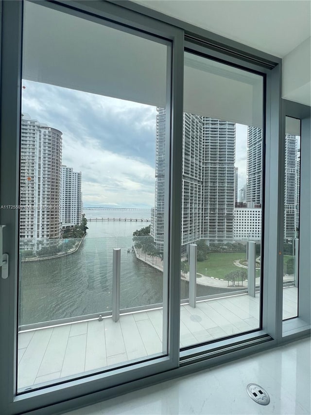 entryway featuring a wall of windows and a water view