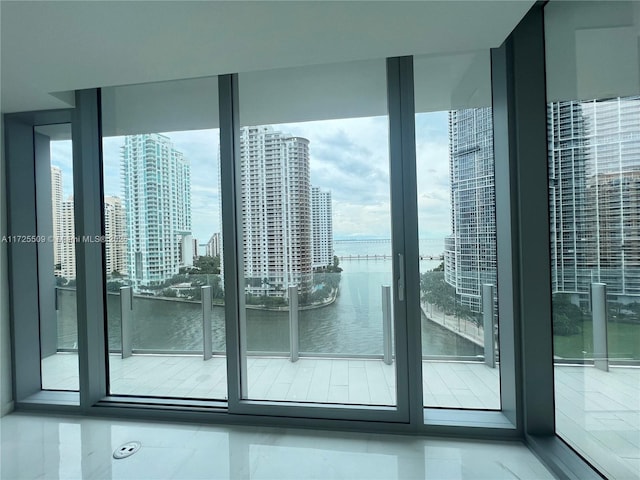 entryway with a wall of windows and a water view