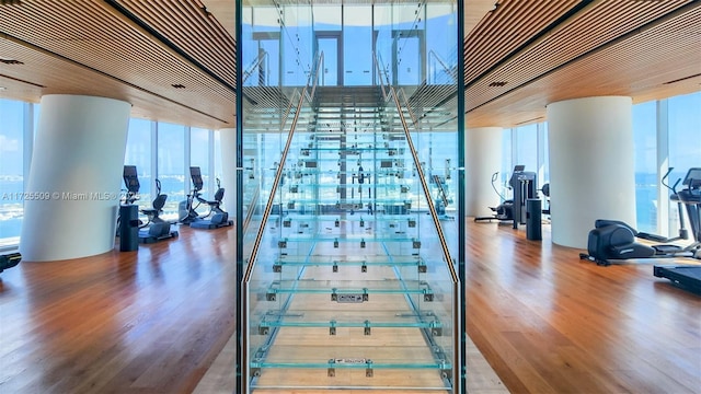 gym with expansive windows and wood finished floors