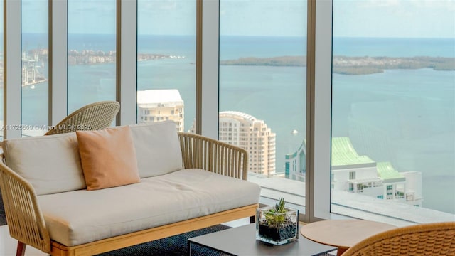 balcony with a water view and an outdoor living space