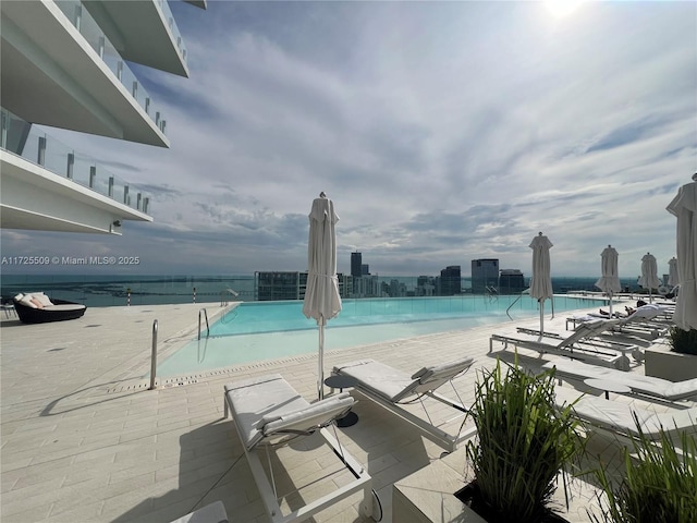 view of swimming pool featuring a city view