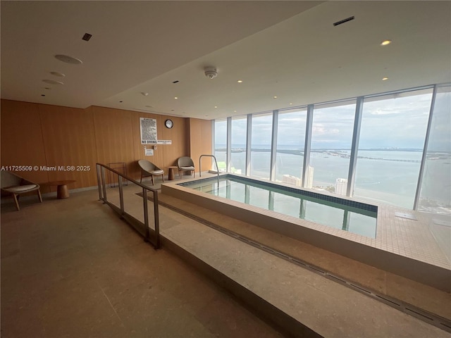 view of swimming pool featuring a water view