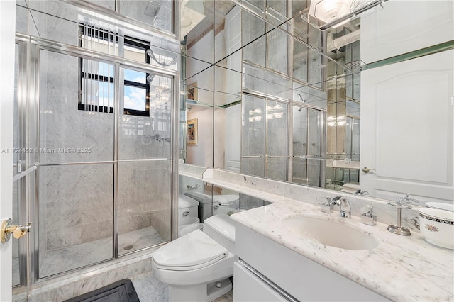 bathroom with toilet, vanity, tile patterned floors, and a shower with door