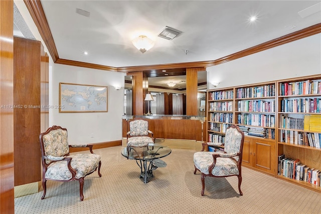 sitting room with crown molding and light colored carpet