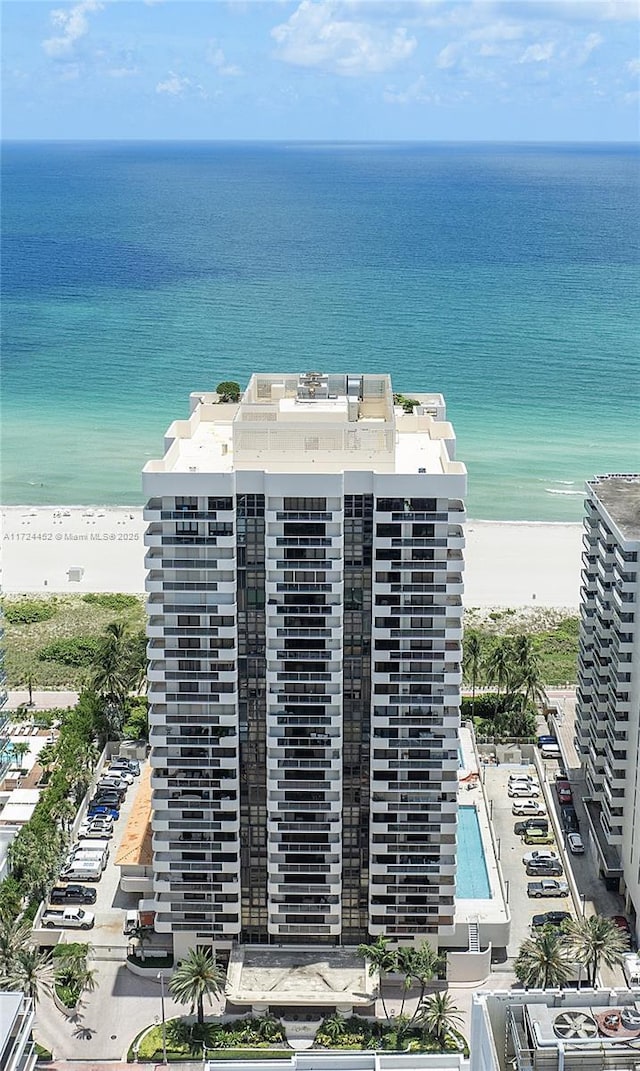 drone / aerial view with a water view and a view of the beach