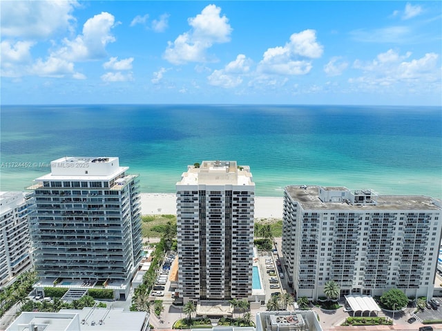 birds eye view of property with a water view and a view of the beach