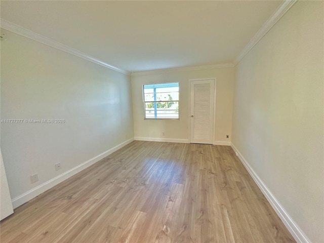 spare room featuring crown molding and light wood-type flooring